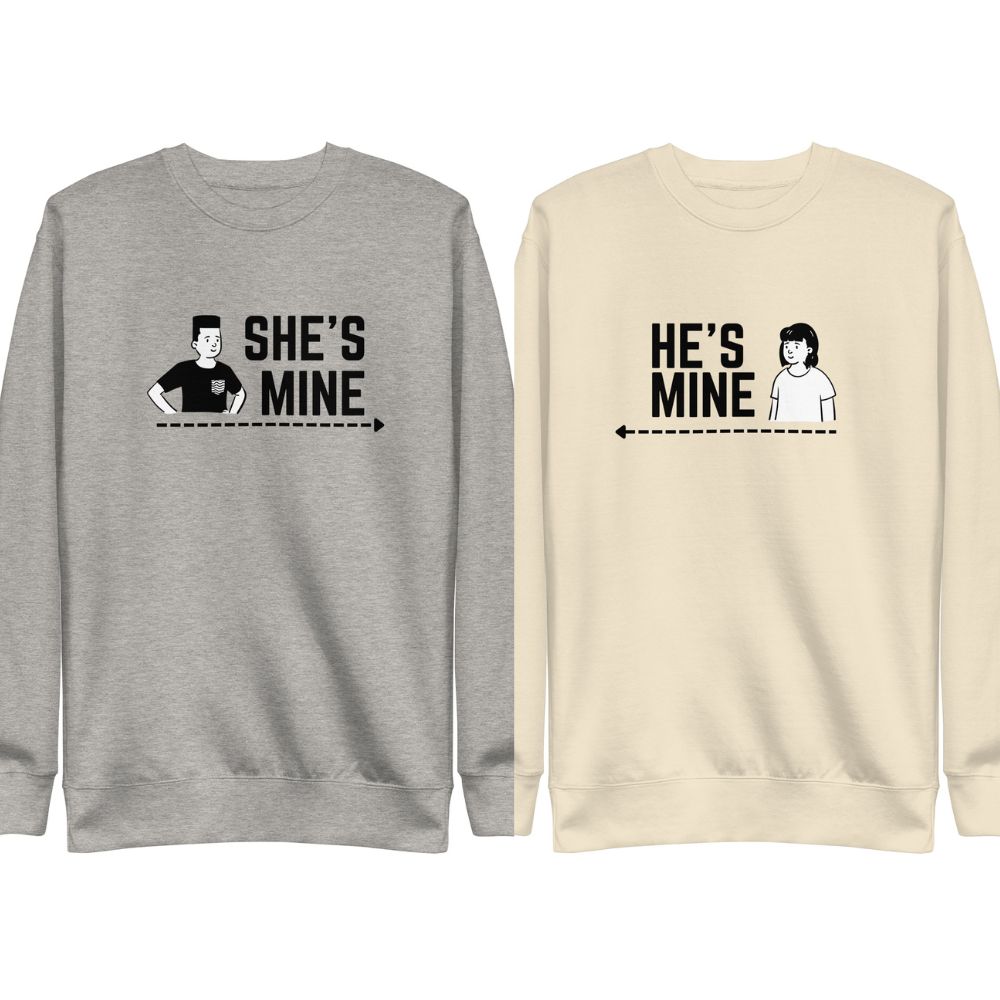 Two matching sweatshirts with SHE'S MINE and HE'S MINE print, pointing at each other