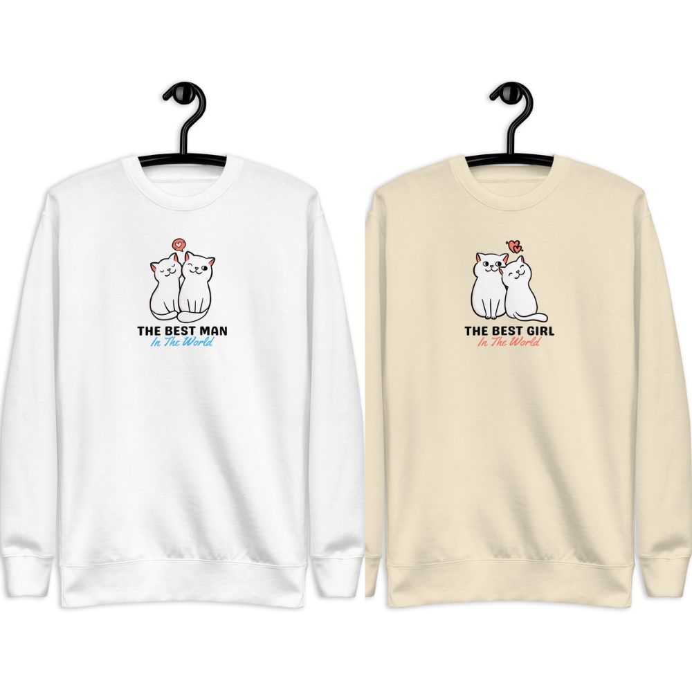 Two matching sweatshirts with cartoon cats and text THE BEST MANGIRL In The World on hangers